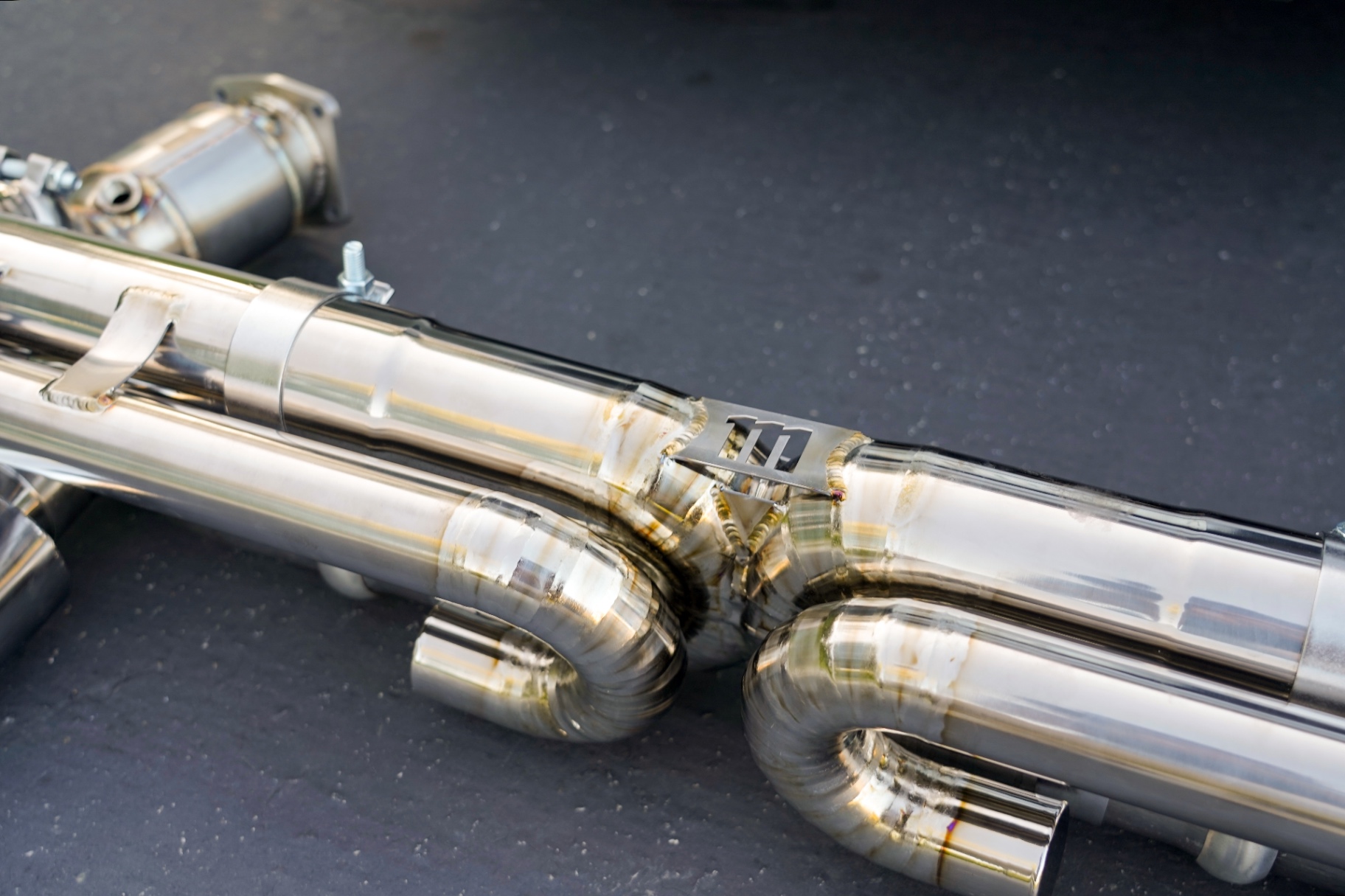Macro shot of titanium welds and X-pipe junction